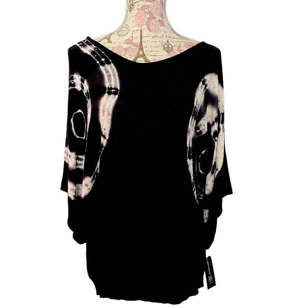 Black and white INC top that pairs well with jeans for a great night out!